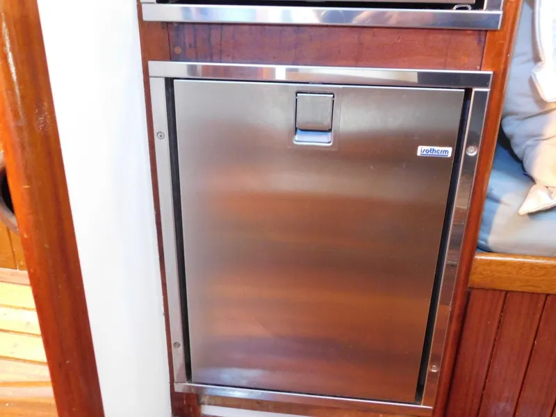 Slide: The Image of Stainless steel door on 1964 Custom 65 Pilothouse Schooner, featuring wooden trim. - 5