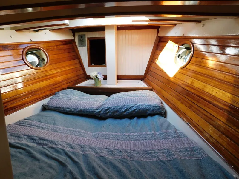 Slide: The Image of Cozy cabin interior of 1964 Custom 65 Pilothouse Schooner with wooden paneling and portholes. - 8