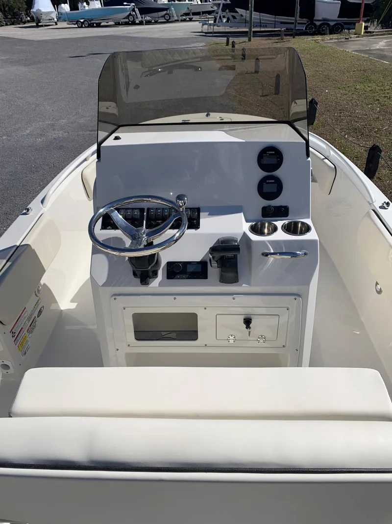 Slide: The Image of 2024 Stingray 173 CC boat console with steering wheel and gauges. - 3