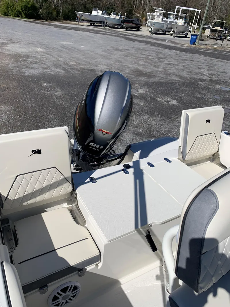 Slide: The Image of 2024 Stingray 173 CC boat with Yamaha 90 HP outboard motor in a marina. - 4