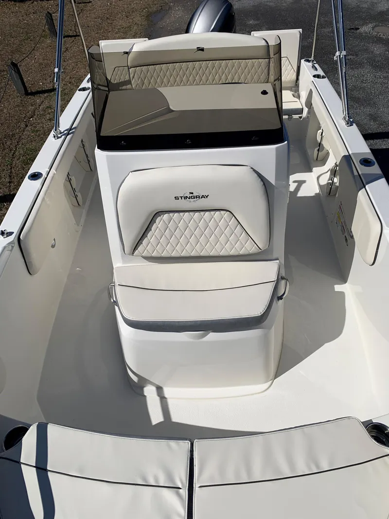 Slide: The Image of 2024 Stingray 173 CC boat interior with cushioned seating and console. - 5