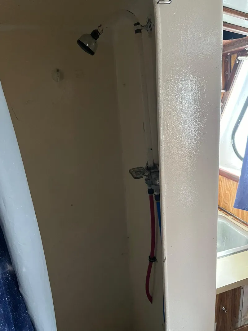 Slide: The Image of Shower area inside a 1983 Swiftships Charter Boat, featuring a compact design. - 19