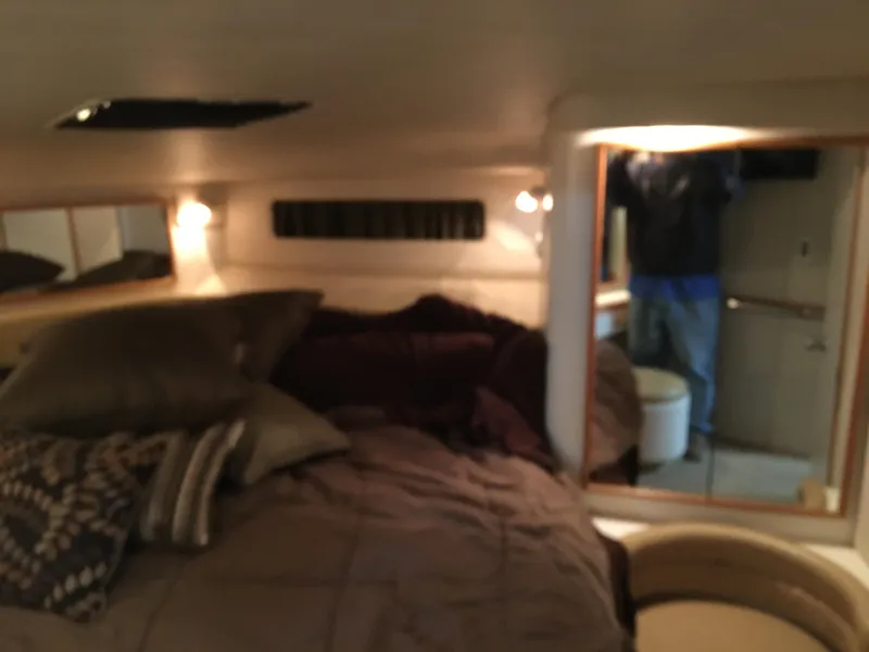 Slide: The Image of Cozy cabin interior of 1994 Sea Ray 500 Sundancer yacht with bed and ambient lighting. - 19