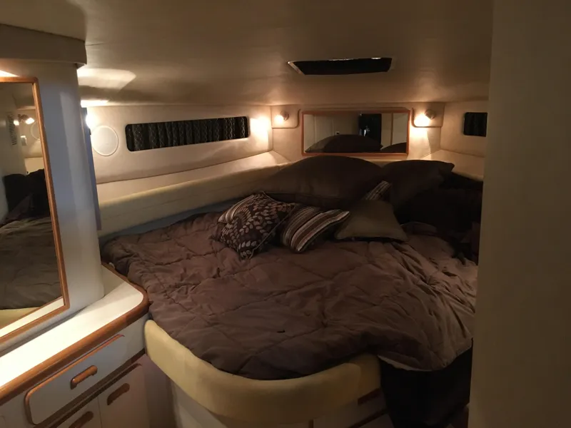 Slide: The Image of Cozy cabin interior of 1994 Sea Ray 500 Sundancer with plush bedding and ambient lighting. - 20