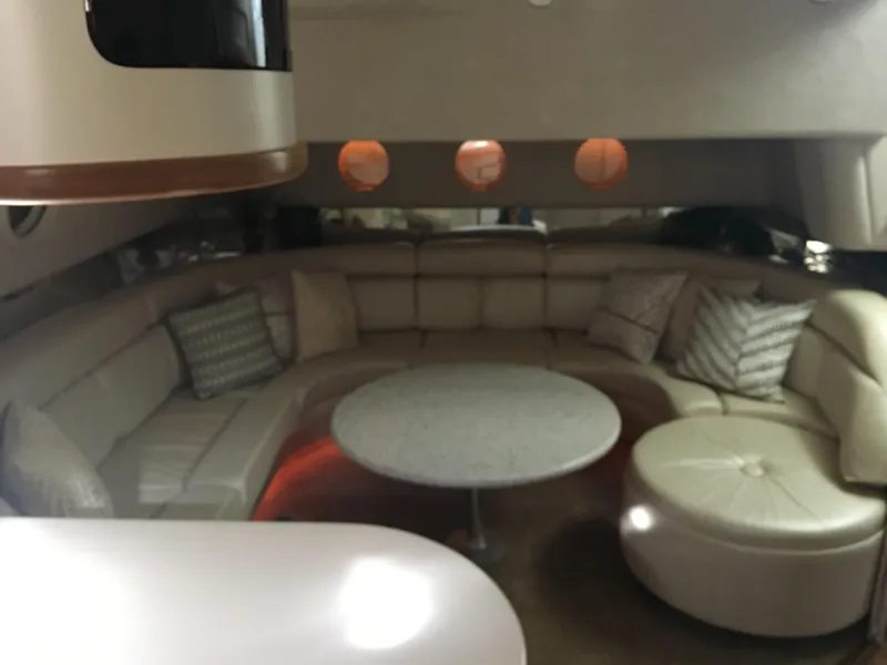 Slide: The Image of Luxurious interior of a 1994 Sea Ray 500 Sundancer yacht with plush seating and round table. - 23