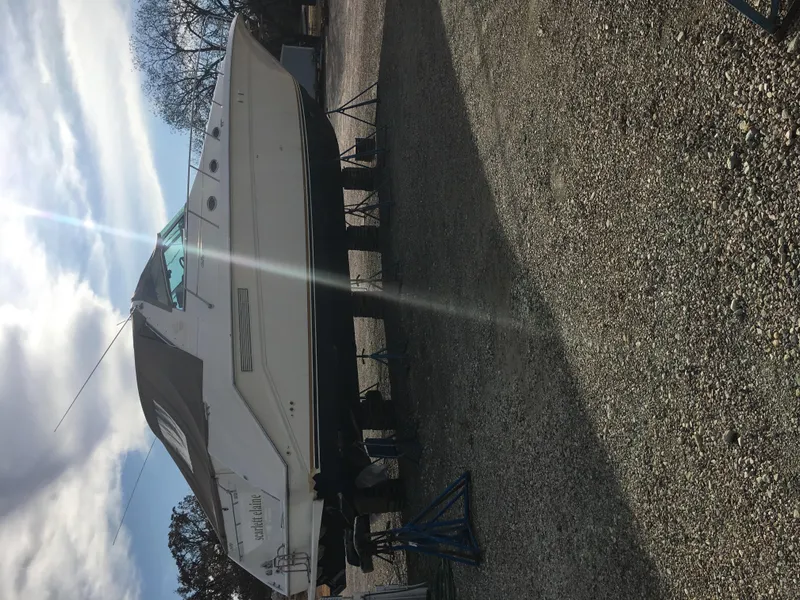 Slide: The Image of 1994 Sea Ray 500 Sundancer yacht on dry dock, side view under cloudy sky. - 8