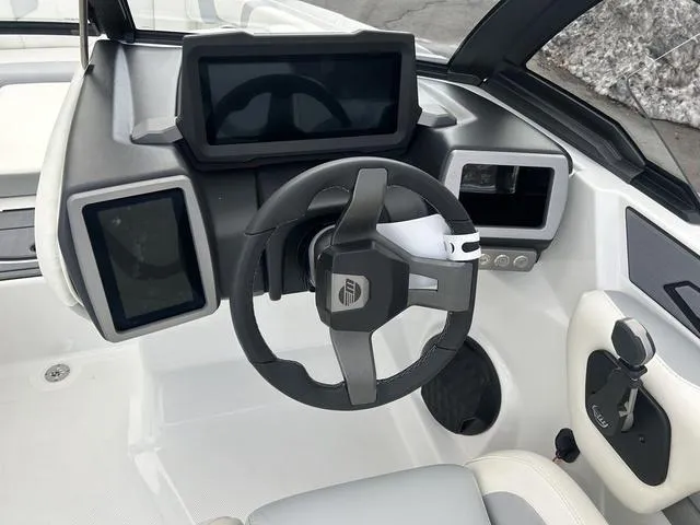 Slide: The Image of 2024 Malibu 21 LX-R boat dashboard with modern steering wheel and digital displays. - 11