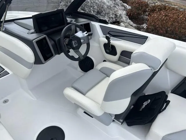 Slide: The Image of 2024 Malibu 21 LX-R boat interior with modern dashboard and comfortable seating. - 12