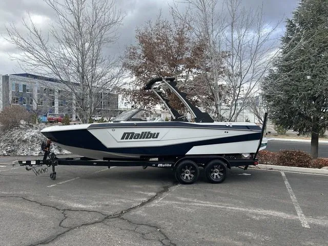 Slide: The Image of 2024 Malibu 21 LX-R boat on a trailer in a parking lot. - 3