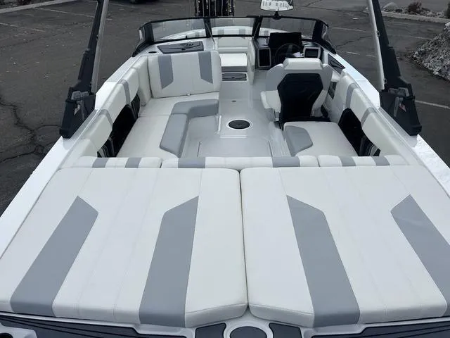 Slide: The Image of 2024 Malibu 21 LX-R boat interior with white and gray seating. - 6