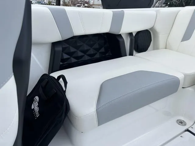 Slide: The Image of 2024 Malibu 21 LX-R boat interior with white and gray seating. - 8