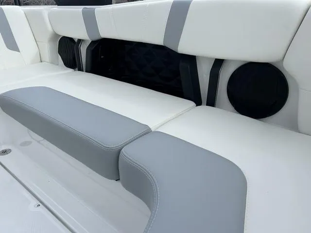 Slide: The Image of 2024 Malibu 21 LX-R boat interior with white and gray seating. - 9