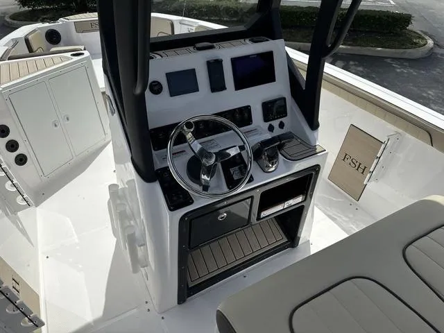 Slide: The Image of 2024 Yamaha Boats 222 FSH Sport E interior seating and helm station. - 10