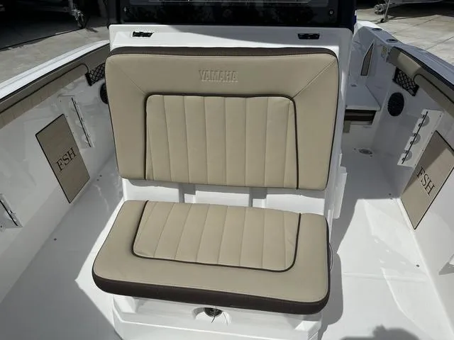Slide: The Image of 2024 Yamaha Boats 222 FSH Sport E interior with storage compartment open. - 15