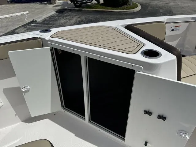 Slide: The Image of 2024 Yamaha Boats 222 FSH Sport E interior seating and storage area. - 19