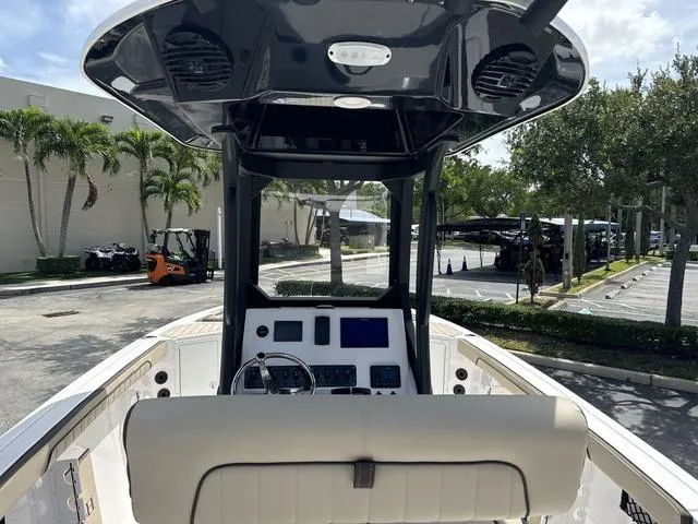 Slide: The Image of 2024 Yamaha Boats 222 FSH Sport E interior, showcasing seating and storage compartments. - 9