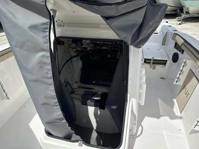 Slide: The Image of 2024 Yamaha Boats 222 FSH Sport E interior with beige seating and storage compartments. - 14