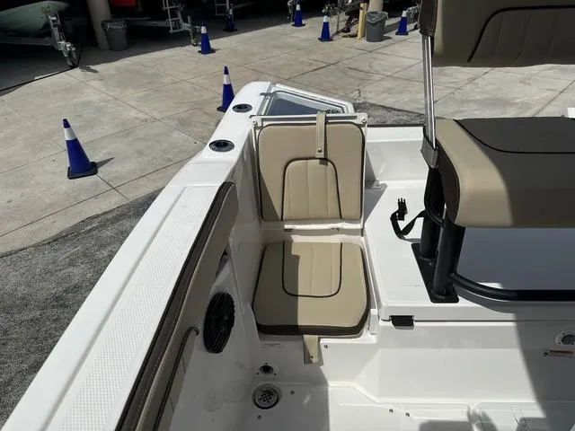 Slide: The Image of 2024 Yamaha Boats 222 FSH Sport E interior, featuring seating and storage compartments. - 16
