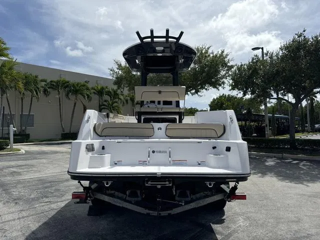 Slide: The Image of 2024 Yamaha Boats 222 FSH Sport E displayed in a showroom. - 4