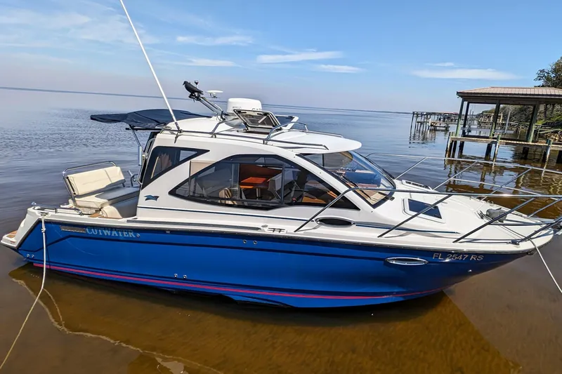 Slide: The Image of 2016 Cutwater 24 boat docked on calm waters. - 0