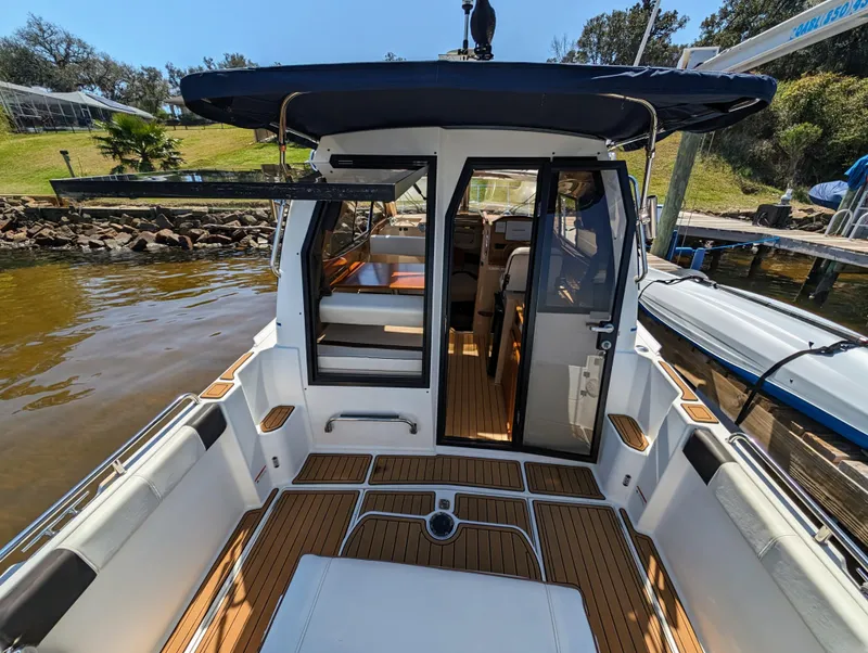 Slide: The Image of 2016 Cutwater 24 boat with open cabin and teak deck at a dock. - 10