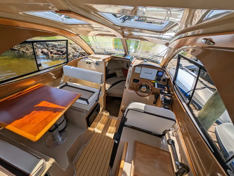 Slide: The Image of Interior of a 2016 Cutwater 24 boat with seating and navigation area. - 13