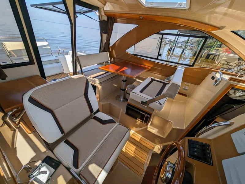 Slide: The Image of Interior of a 2016 Cutwater 24 boat with seating and dining area. - 14