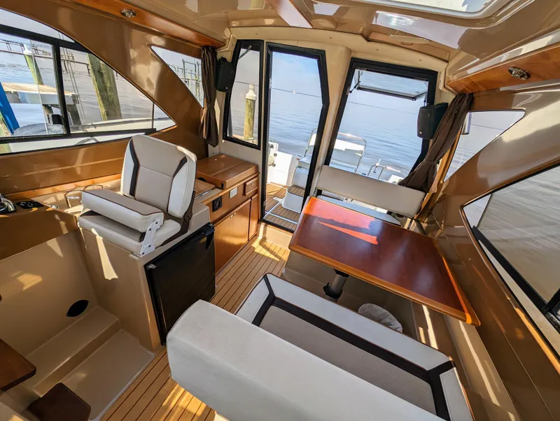 Slide: The Image of Interior of 2016 Cutwater 24 boat with seating, table, and waterfront view. - 15