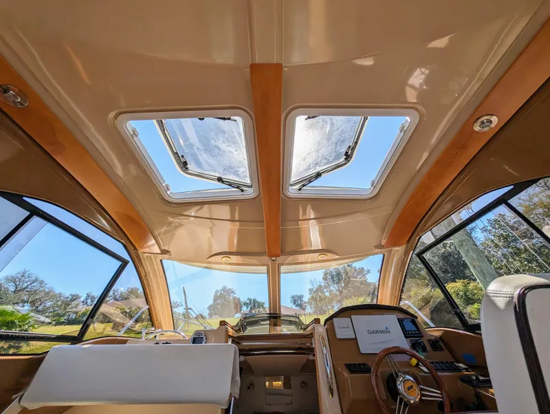 Slide: The Image of Interior view of 2016 Cutwater 24 boat with sunroof and steering console. - 16
