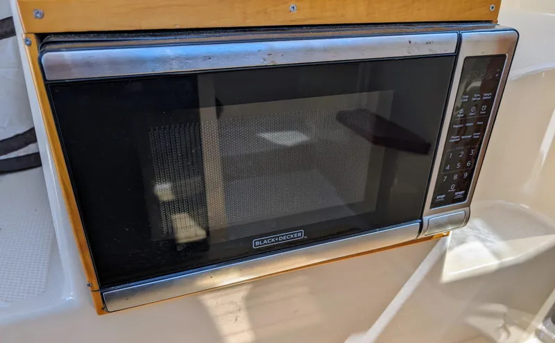 Slide: The Image of Built-in microwave in 2016 Cutwater 24 boat kitchen. - 18