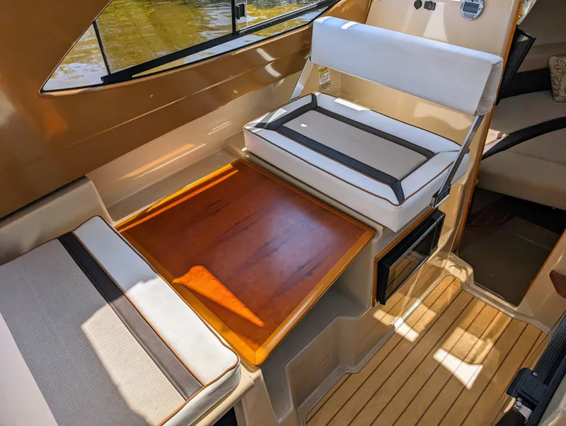 Slide: The Image of Interior seating and table of a 2016 Cutwater 24 boat. - 19