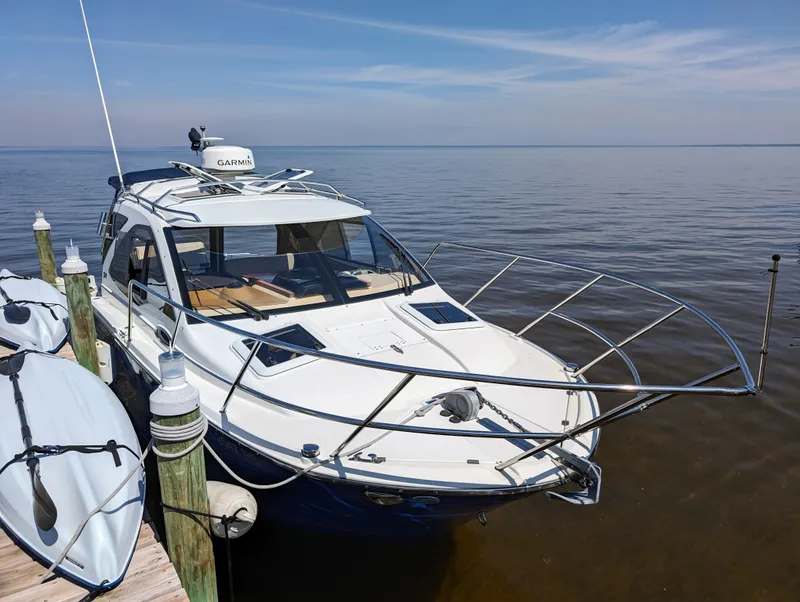 Slide: The Image of 2016 Cutwater 24 boat docked by the pier on a calm day. - 2