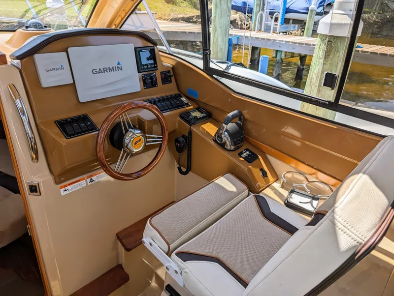 Slide: The Image of 2016 Cutwater 24 boat helm with Garmin navigation system and comfortable captain's chair. - 21