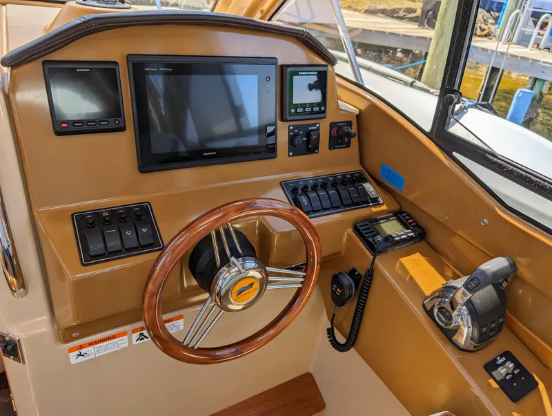 Slide: The Image of 2016 Cutwater 24 boat helm with steering wheel, navigation screens, and control panels. - 22