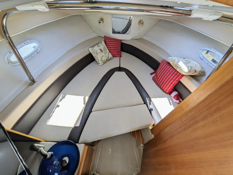 Slide: The Image of Interior cabin of a 2016 Cutwater 24 boat with cushions and portholes. - 23