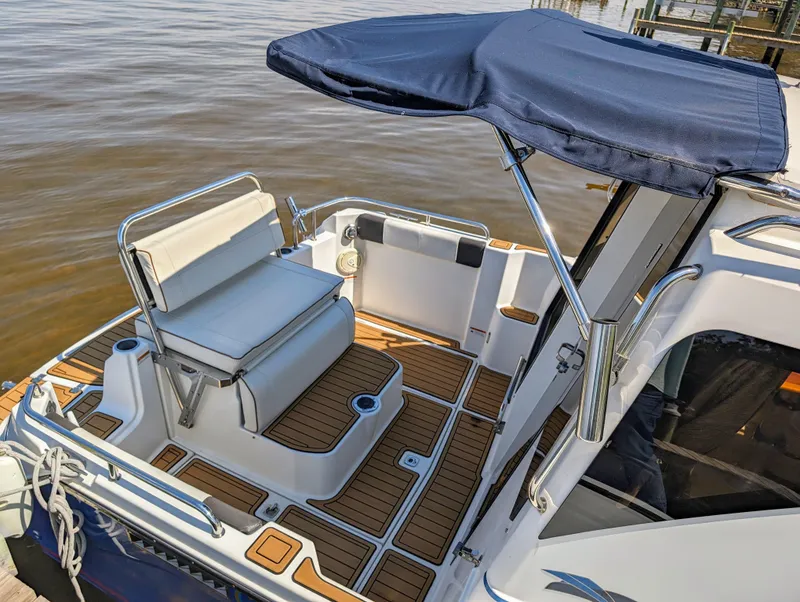 Slide: The Image of 2016 Cutwater 24 boat with seating and canopy on the water. - 3