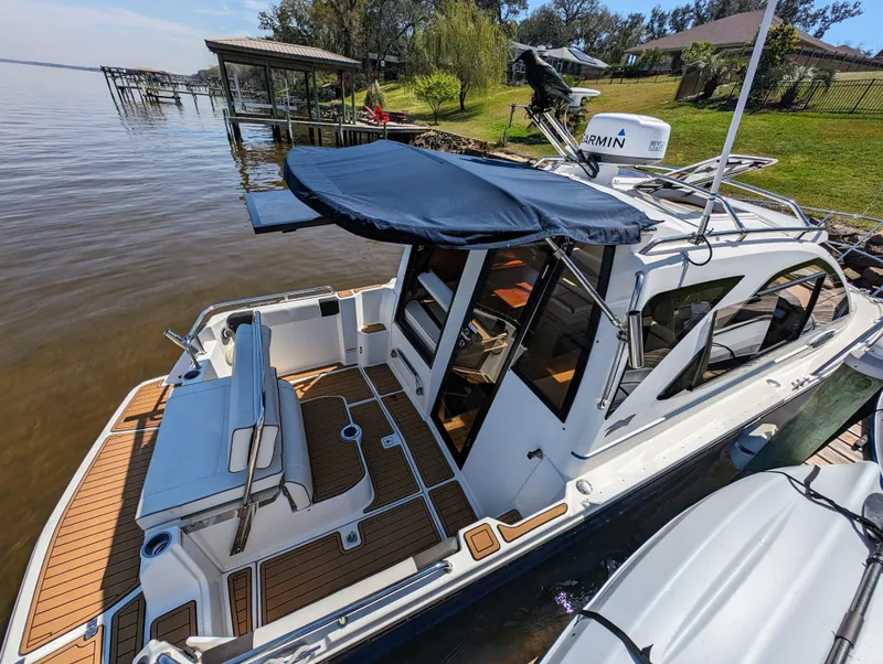 Slide: The Image of 2016 Cutwater 24 boat docked by a lakeside with a Garmin radar. - 5