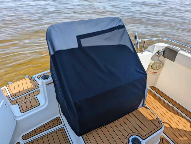 Slide: The Image of Covered helm station on a 2016 Cutwater 24 boat with teak flooring. - 8