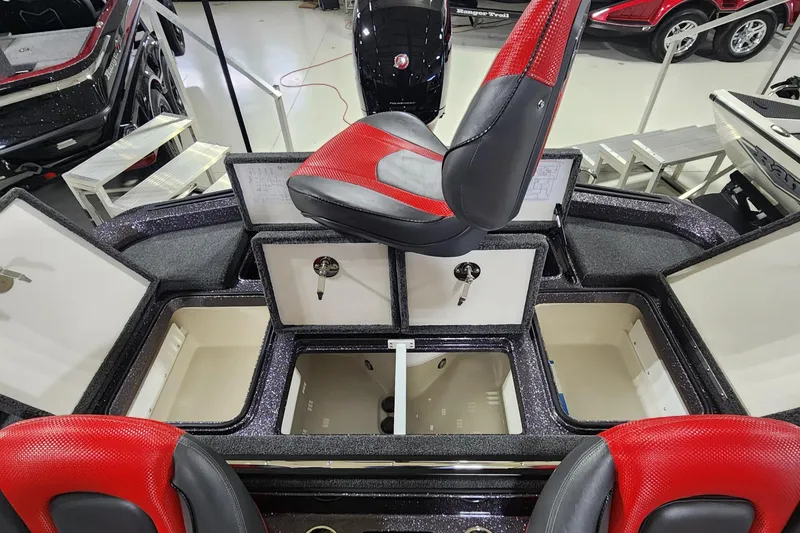 Slide: The Image of 2024 Ranger Z518 boat interior with red seats and open storage compartments. - 11