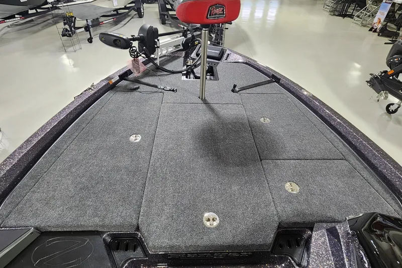 Slide: The Image of 2024 Ranger Z518 boat interior with gray carpet and red seat. - 4