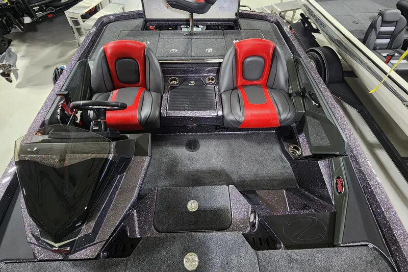Slide: The Image of 2024 Ranger Z518 bass boat with red and black seats, cockpit view. - 6