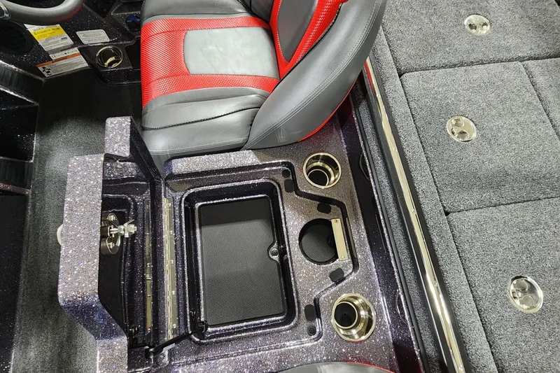 Slide: The Image of 2024 Ranger Z518 boat interior with storage compartment and red-black seating. - 9