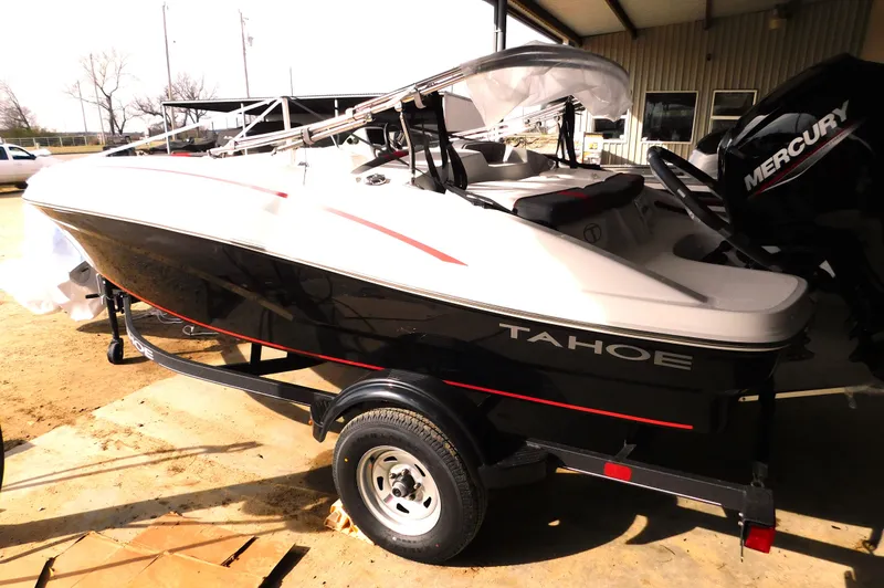 Slide: The Image of 2024 Tahoe T16 boat on trailer, black and white design, outdoor setting. - 26
