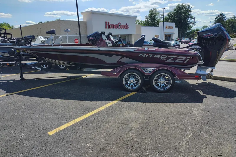 The Image of 2024 Nitro Z21 XL boat parked in a shopping center lot, sunny day. - 0