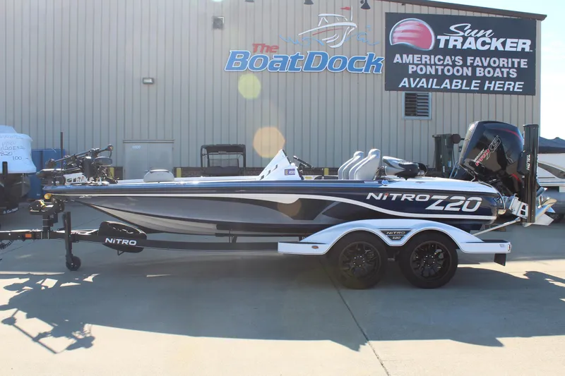The Image of 2024 Nitro Z20 boat on trailer outside dealership, showcasing sleek design and powerful engine. - 0
