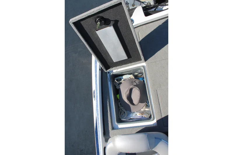 Slide: The Image of Open storage compartment on 2024 Nitro Z20 boat with hat and gear inside. - 16