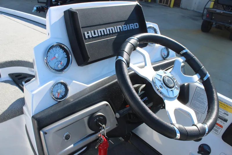 Slide: The Image of 2024 Nitro Z20 boat dashboard with steering wheel and Humminbird display. - 19