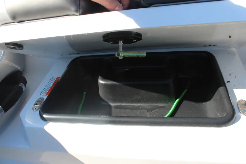 Slide: The Image of 2024 Nitro Z20 boat storage compartment with green cable inside. - 21