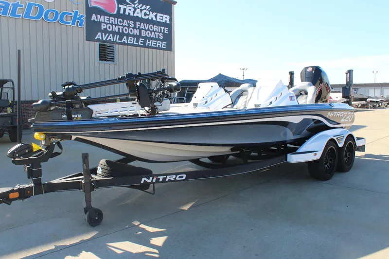 Slide: The Image of 2024 Nitro Z20 boat on trailer, displayed outdoors at dealership. - 7