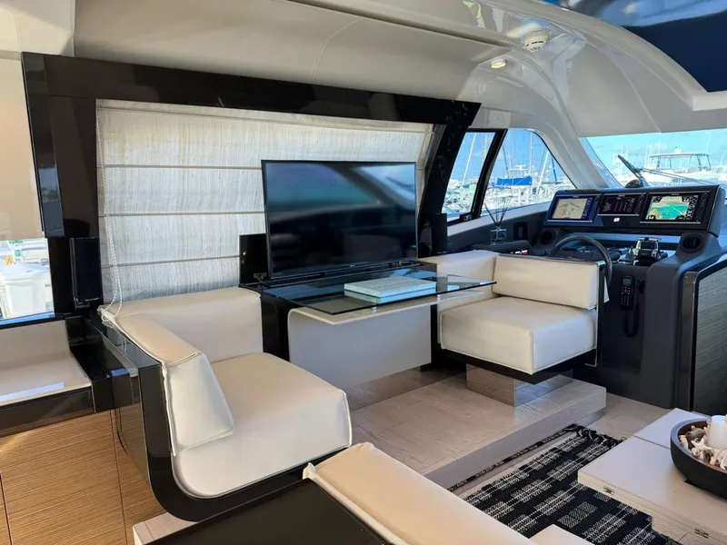 Slide: The Image of Luxurious interior of 2016 Ferretti Yachts 550 with modern seating and navigation area. - 11